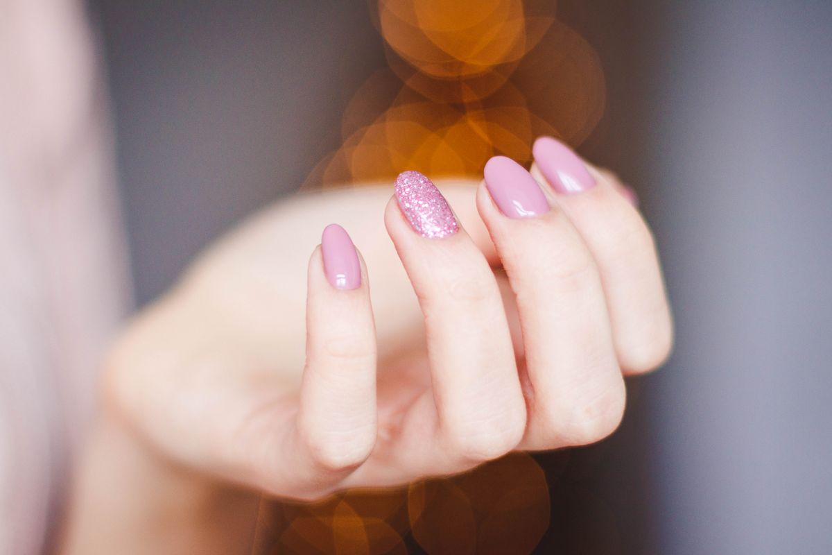 Finished pink manicure with glitter accent nail